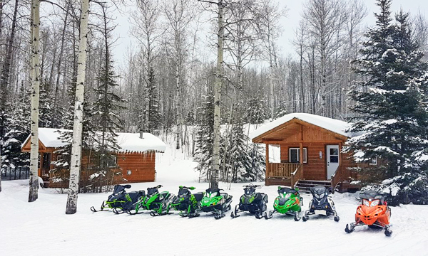 Snowmobiles in front of Cabin